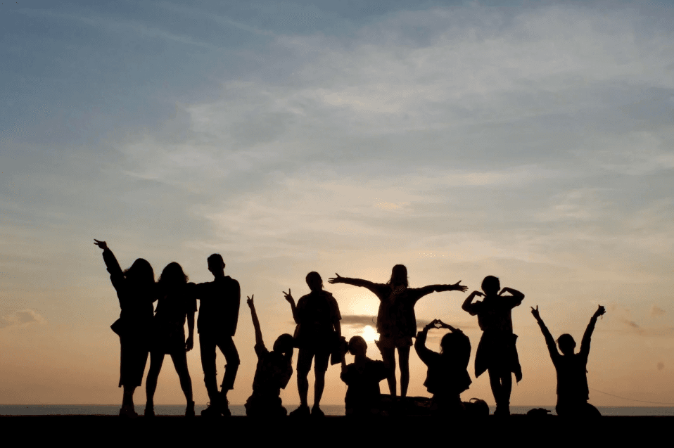 Friends celebrating at sunset on the water